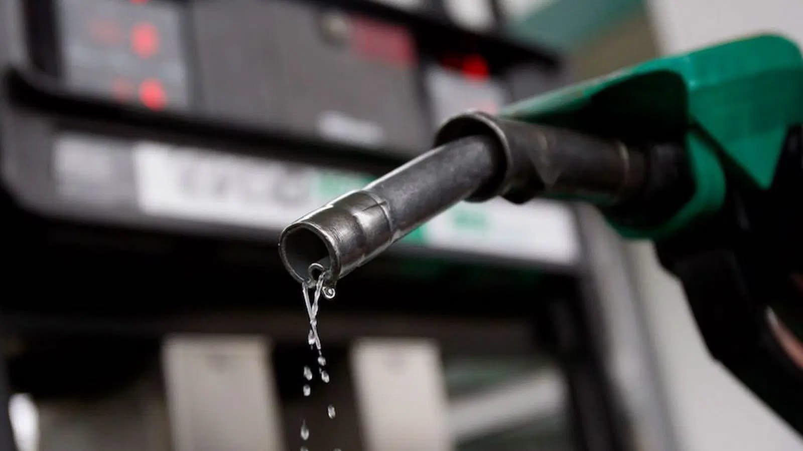 Fuel attendant dispensing petrol at a filling station in Nigeria as oil marketers reduce pump prices.