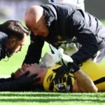 Chelsea goalkeeper Emiliano Martínez receives treatment after a head collision with Everton defender Jarrad Branthwaite at Hill Dickinson Stadium.